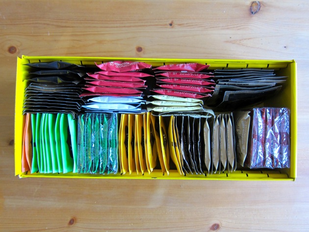a yellow box full of tea bags in paper packages