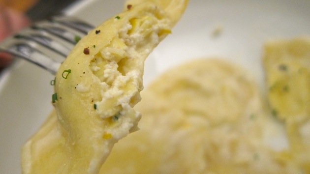 a cross section of ravioli on the end of a fork